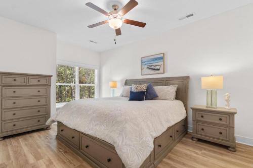 a bedroom with a bed and a ceiling fan at Munn Hub Live the Dream 4 Bdrm Home with Pool in Pawleys Island