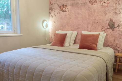 a bedroom with a large white bed with red pillows at Willow Hideaway in Arendonk