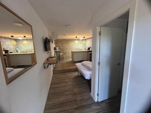 a room with a hallway with two beds and a mirror at Casa Fritz in Llagostera