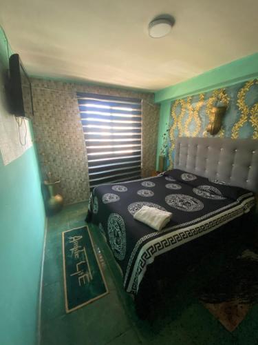 a bedroom with a bed and a window at Hotel del valle in Melipilla