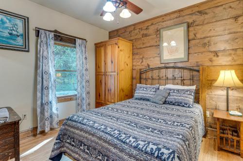a bedroom with a bed and a wooden wall at Deck and Sauna Avalon Woods Riverfront Retreat in Marble