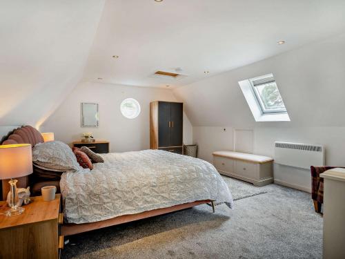 a bedroom with a bed and a desk and a window at 1 bed in Mamhilad 83405 in Mamhilad
