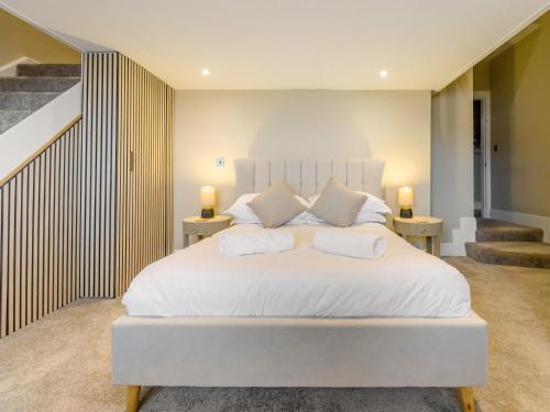 a bedroom with a large white bed with two tables at 7 Bed in Whitchurch 95835 in Prees