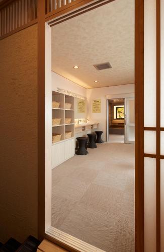 a door leading into a tasting room withools in the background at Wakamatsu Honten in Narita