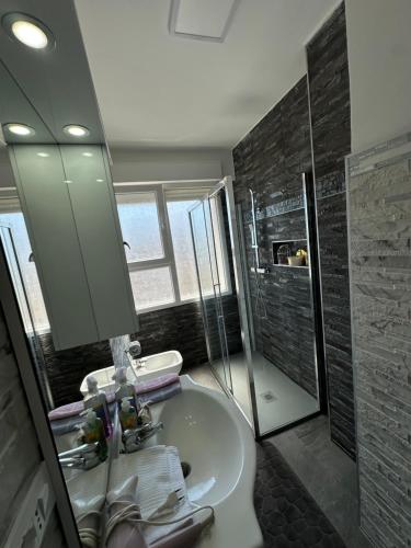 a bathroom with a sink and a shower at Appartamento Vacanza Centro Asti in Asti