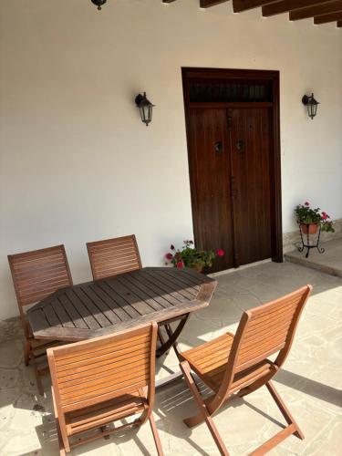 a patio with a table and two chairs and a door at Calypso Historic Village House in Limassol