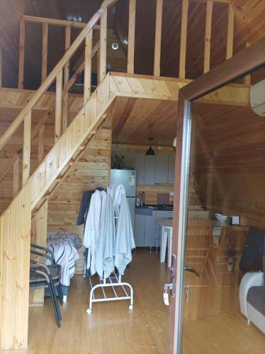 a room with a staircase in a wooden house at Koxta in Akhaliki