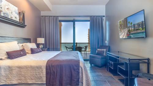 a bedroom with a bed and a view of the ocean at 2BR 2BA condo @ Las Palomas Cabrillo 804 in Puerto Peñasco