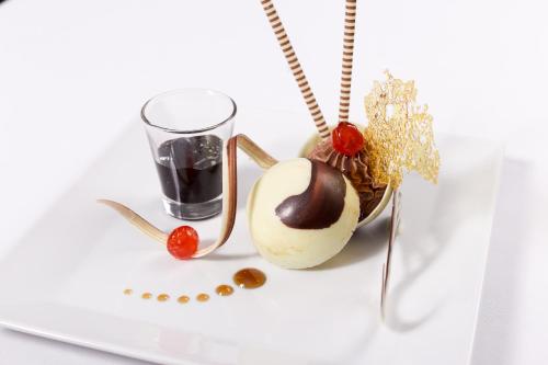 a white plate with a dessert and a glass at Pickalbatros Aqua Blu Sharm El Sheikh in Sharm El Sheikh