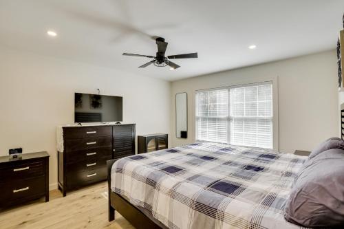 a bedroom with a bed and a ceiling fan at Wooded Retreat with Pet-Friendly Yard in Standish in Standish