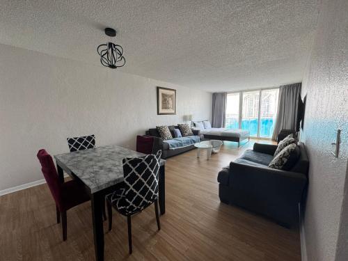 a living room with a table and a couch at Ocean Reserve Luxury Condo Sunny Isles Beach in Sunny Isles Beach