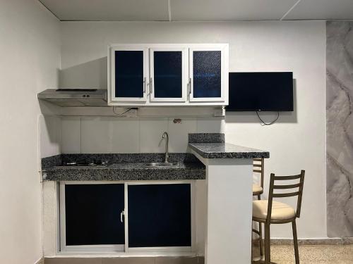 a kitchen with white cabinets and a counter top at Dominico Colonial in Santo Domingo