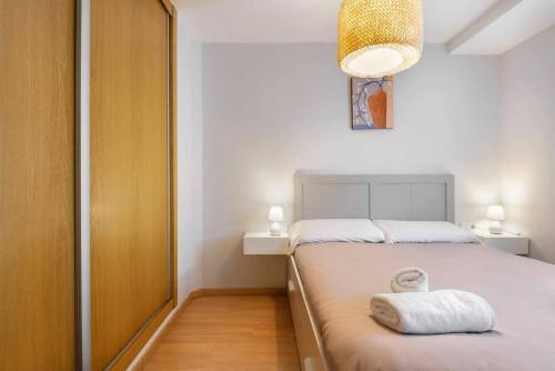 a bedroom with a bed with a towel on it at Casa Constanza, acogedor alojamiento en Panticosa in Panticosa