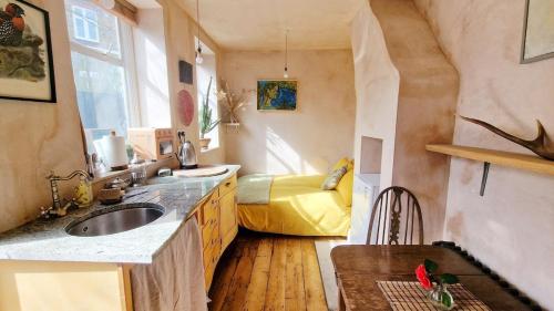 a kitchen with a sink and a bed in a room at Private studio New Cross patio garden in London