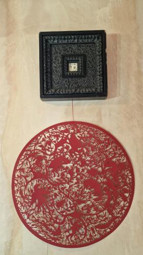 a picture frame and a red rug on a wall at Private studio New Cross patio garden in London