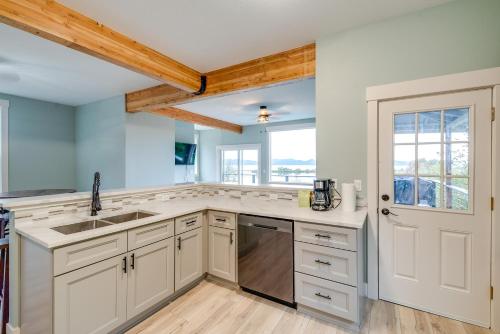 a kitchen with white cabinets and a sink at Astoria Home Base with River Views, 3 Mi to Dtwn! in Tongue Point Village