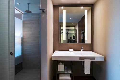 a bathroom with a sink and a mirror at AC Hotel by Marriott Santa Fe in Mexico City