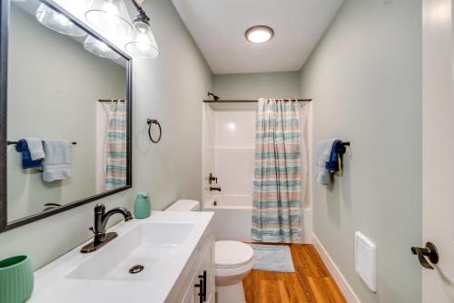 a bathroom with a sink and a toilet and a mirror at 4 Blocks to Riverwalk Updated Astoria Studio in Tongue Point Village