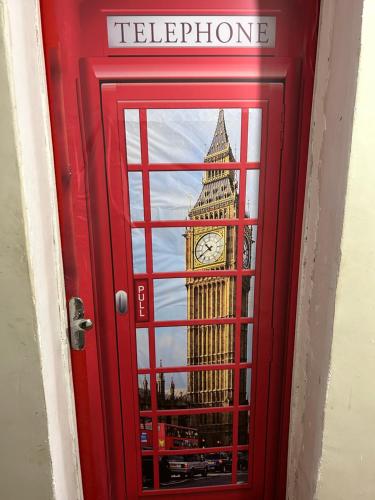 a reflection of the big ben clock tower in a window at Guest House BH in Belo Horizonte