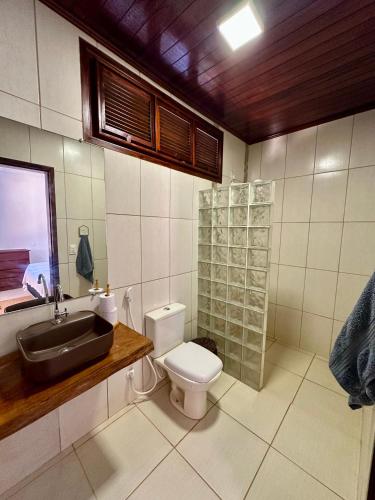 a bathroom with a sink and a toilet at Pousada Villa do Sol Taiba in Taíba