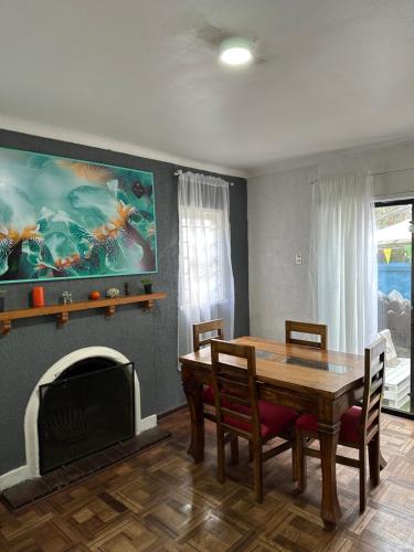 a dining room with a table and a fireplace at Hostel Gloria Viña in Viña del Mar