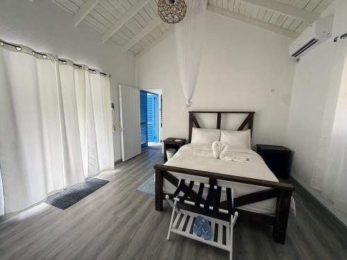 a bedroom with a bed and a table with chairs at The GRΣΣK Cottage in Kingstown