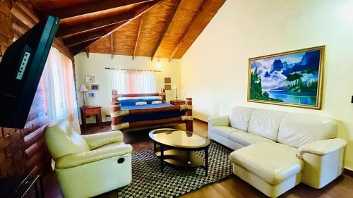 a living room with a couch and a bed at Luxury Villa Heated Pool, Firepit & Pool Table in Arroyo Frío
