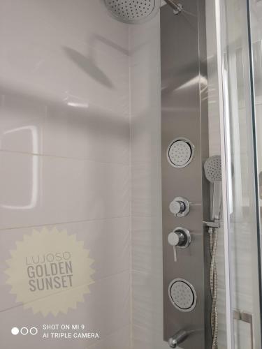 a shower with a glass door in a bathroom at Lujoso Golden Sunset in Oropesa del Mar