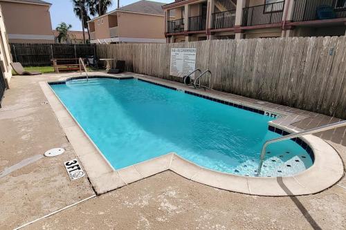 a swimming pool in front of a fence at Great Location Pool Near the Beach in South Padre Island