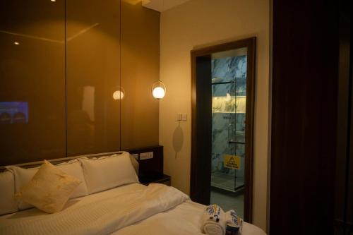 a bedroom with a bed and a large mirror at Awka Luxury One Bed in Awka