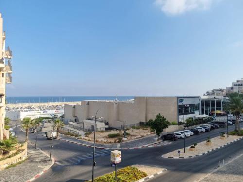 a street with cars parked on the side of a road at Beach Suite Israel- Private Jacuzzi Sea View Balcony, Off-Site Spa ביץ סוייט ישראל- ג'קוזי פרטי עם נוף ים, אפשרות לספא מוזל in Ashqelon