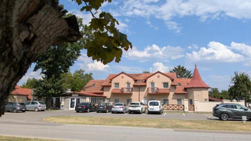 a building with cars parked in a parking lot at A-Termal Palić in Palić