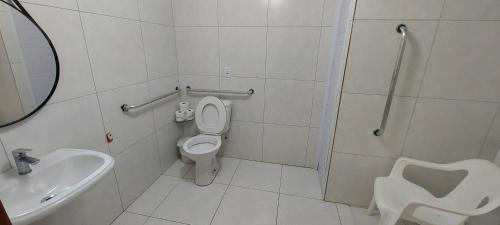 a bathroom with a toilet and a sink and a shower at Flamboyant Hotel in Barra Velha