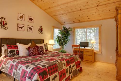 a bedroom with a bed and a desk with a television at Near Hikes Arnold Cabin with EV Charger and Fire Pit in Arnold