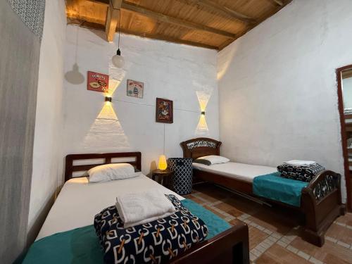 a room with two beds and a chair in it at Maravilla de cabaña grupal 5-10 personas parking, wifi, campestre, cercana in Jardin