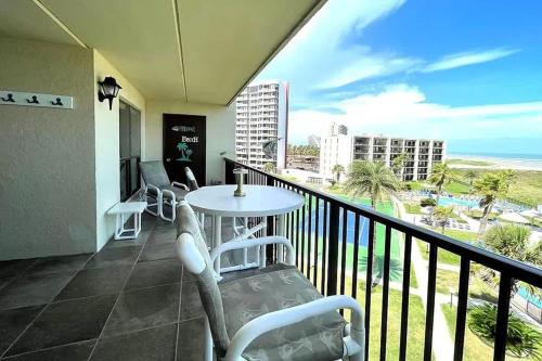 a balcony with a table and chairs and the ocean at Top Floor Ultimate Beachfront Luxury Remodeled in South Padre Island