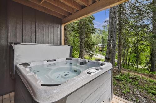 a jacuzzi tub sitting inside of a house at Alpine Glow Ski Haus in Whitefish