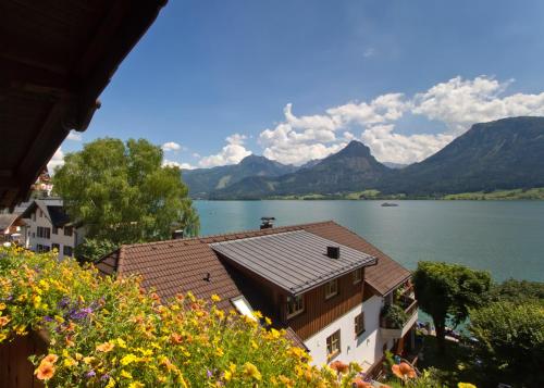 a view of a lake with mountains in the background at Hotel Weisser Hirsch in St. Wolfgang