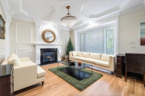 a living room with a white couch and a fireplace at Share Home- Cozy Getaway in Vancouver in Vancouver