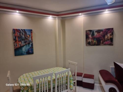a bedroom with a crib and two pictures on the wall at Luxury Two Bedrooms and two balcony beachfront apartment in Vlorë