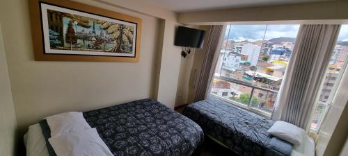 a hotel room with a bed and a window at RESIDENCIAL QUIÑONES in Cusco