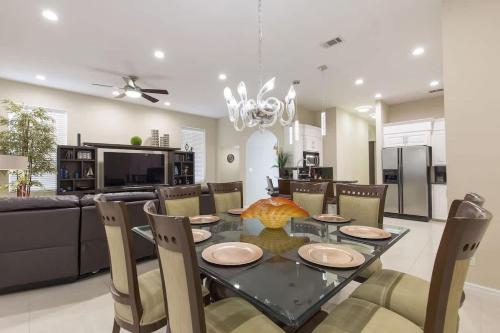 a dining room with a table and chairs and a kitchen at Big Private Luxury Home in Beach Gated Community in South Padre Island