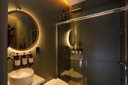 a bathroom with a shower and a toilet and a sink at W Airport Rooms Recife in Recife