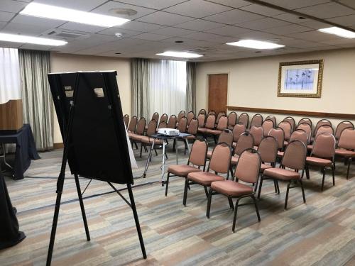an empty room with chairs and a projection screen at Holiday Inn Portland-By the Bay by IHG in Portland