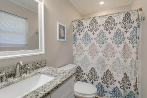 a bathroom with a toilet and a shower curtain at Lovely Emerald Isle Home, Walk to Beach! in Emerald Isle