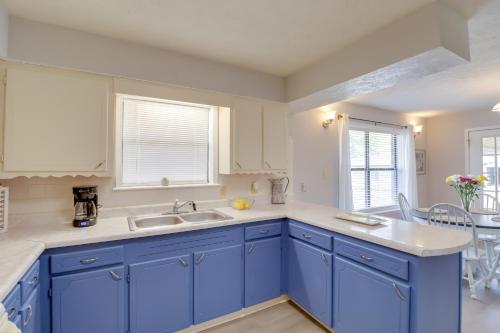 a kitchen with blue cabinets and a sink at Charming Mountain Home Getaway with Gas Grill! in Mountain Home