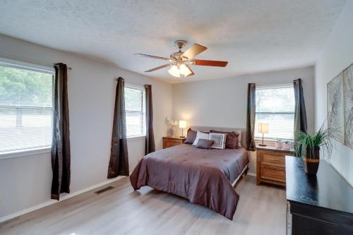 a bedroom with a bed and a ceiling fan at Charming Mountain Home Getaway with Gas Grill! in Mountain Home