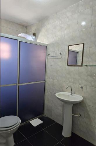 a bathroom with a toilet and a sink at Hotel Diplomata in Tupanciretã