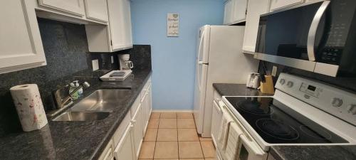 a kitchen with a sink and a stove top oven at 3 bedr w-private pool 1 block to beach Pets Ok in South Padre Island