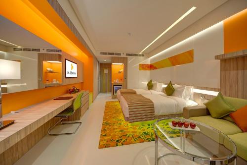 a hotel room with a bed and a couch at Al Khoory Atrium in Dubai